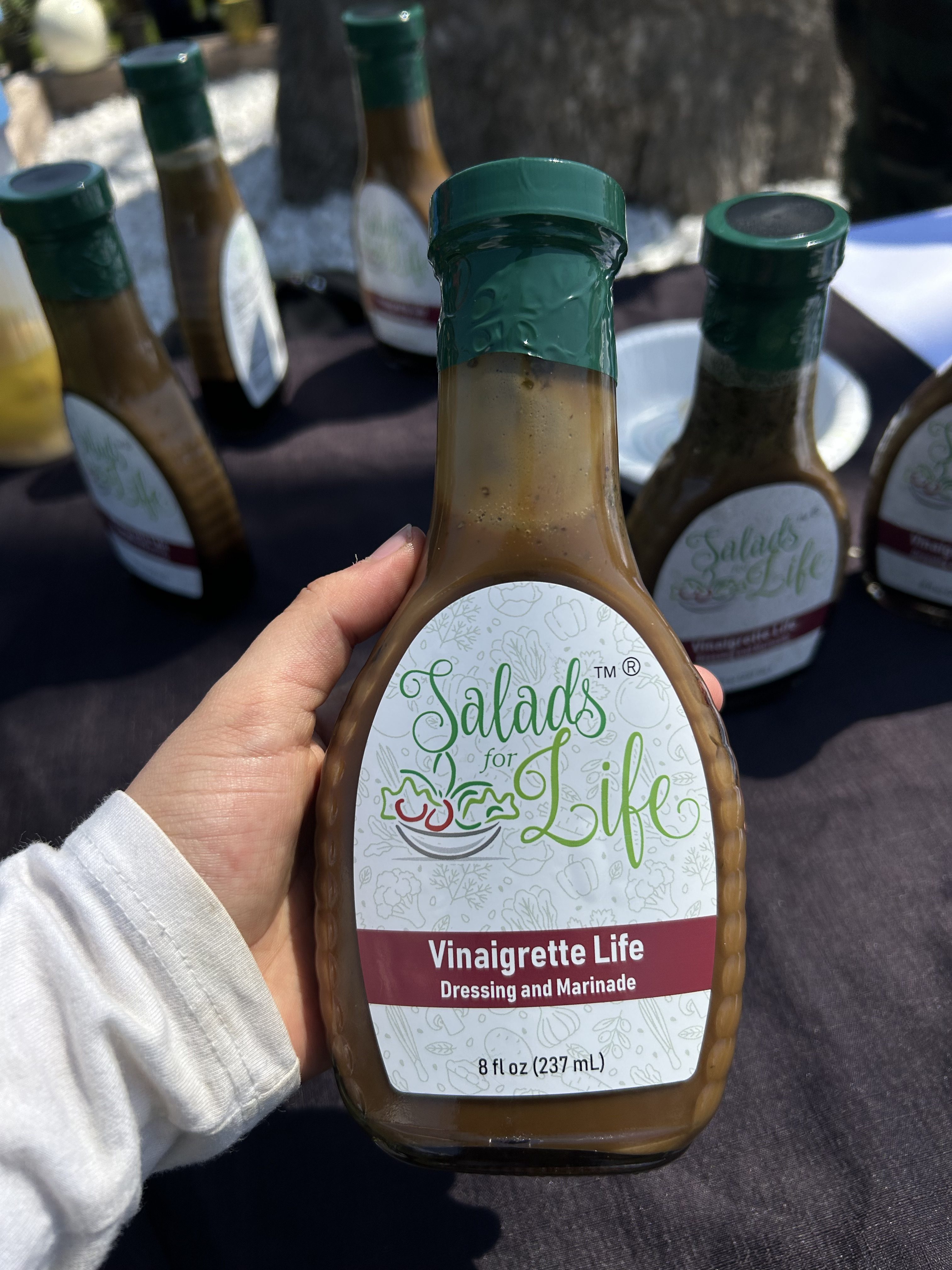 hand holding vegan and organic dressing