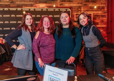 4 women standing together at the December 2023 Chelas con Contratistas event - Yazmin (manager), Bridget (CEO), Claudia (contractor), and Andrea (intern)