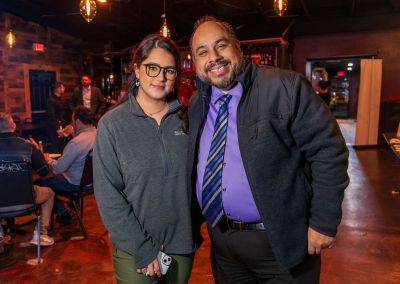 A woman and a man standing together at the December 2023 Chelas con Contratistas event at Salpicon in Detroit.