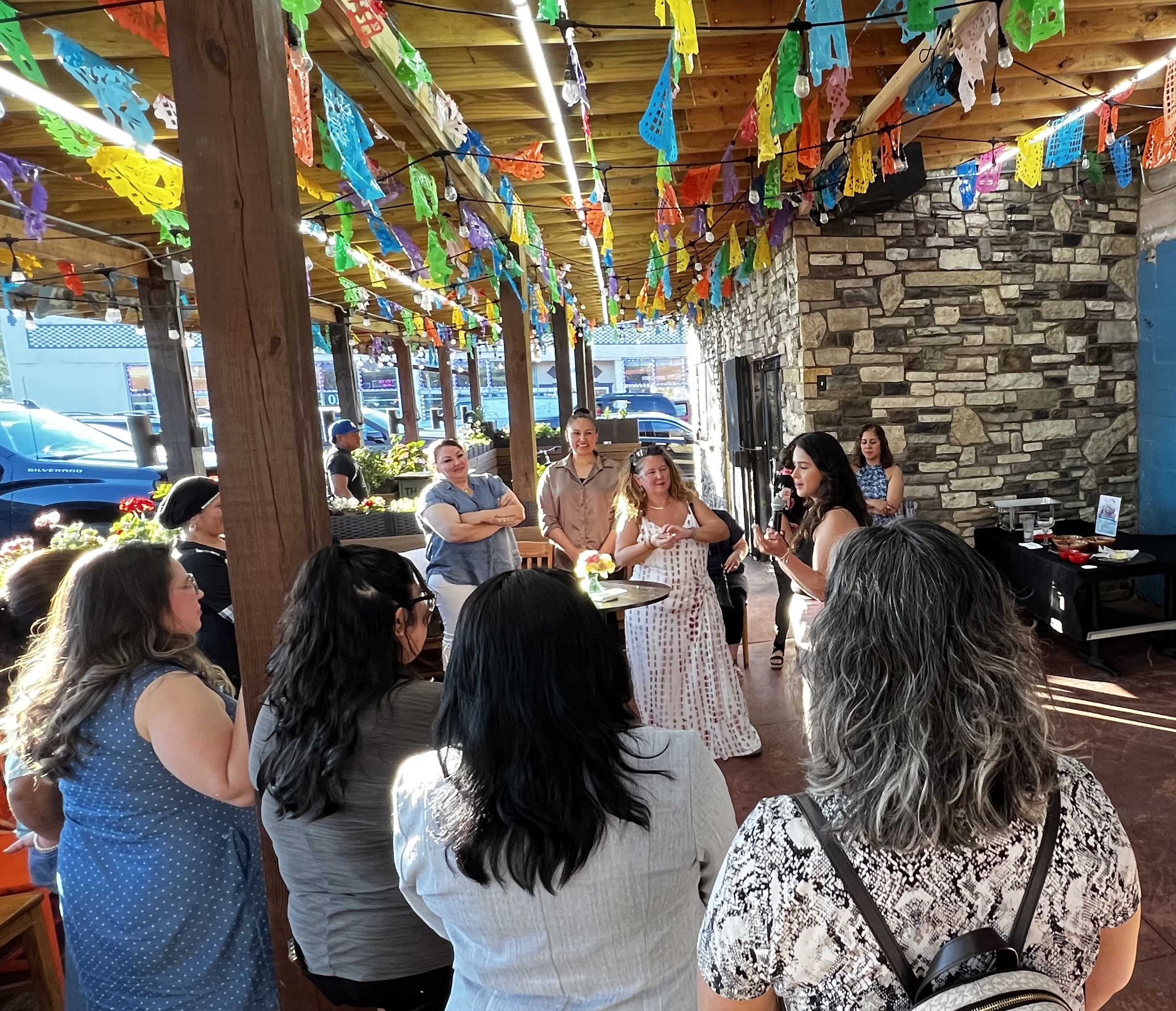 Women gathered in a circle, celebrating a and empowering each other at networking event